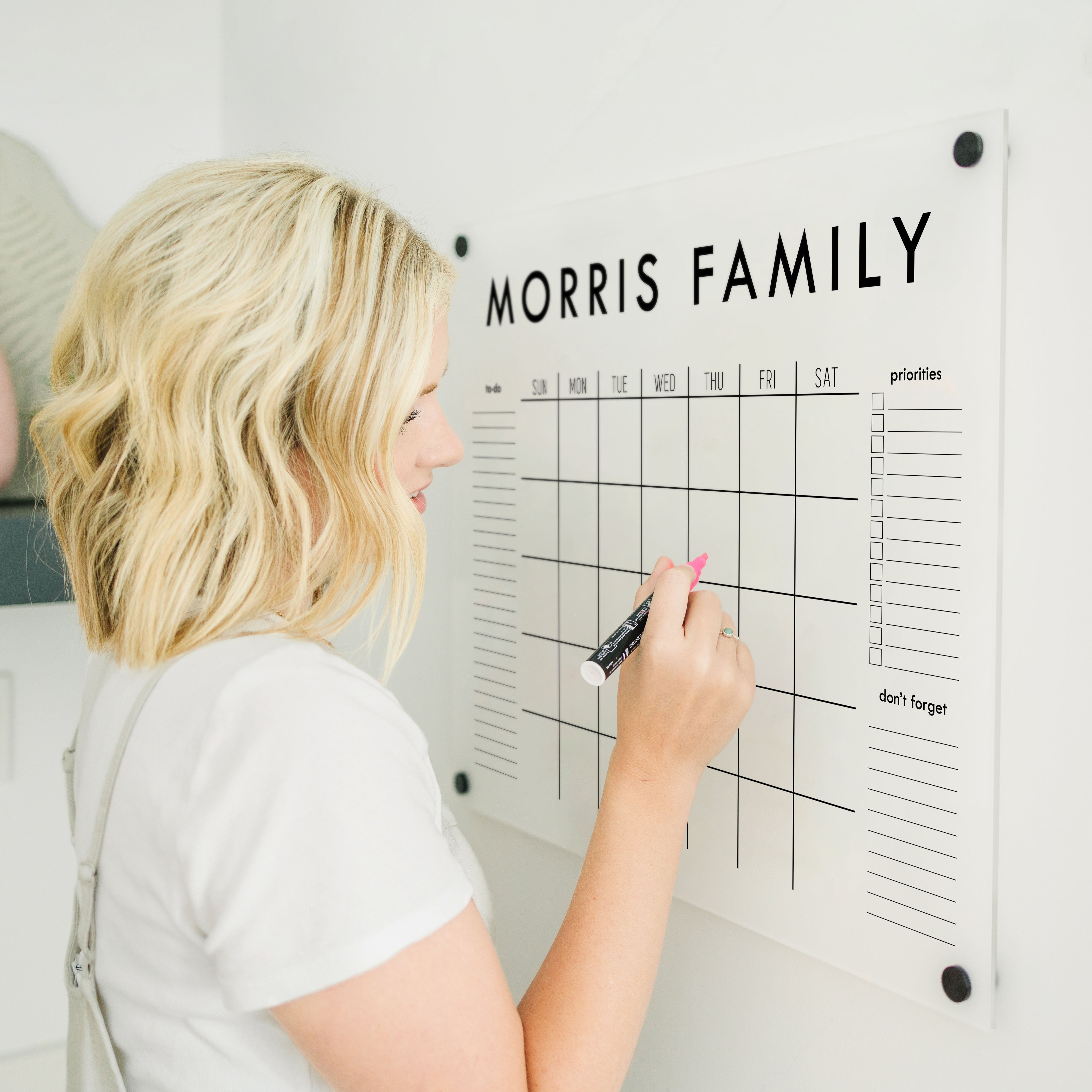 A Dry-erase monthly calender made of acrylic hanging on the wall