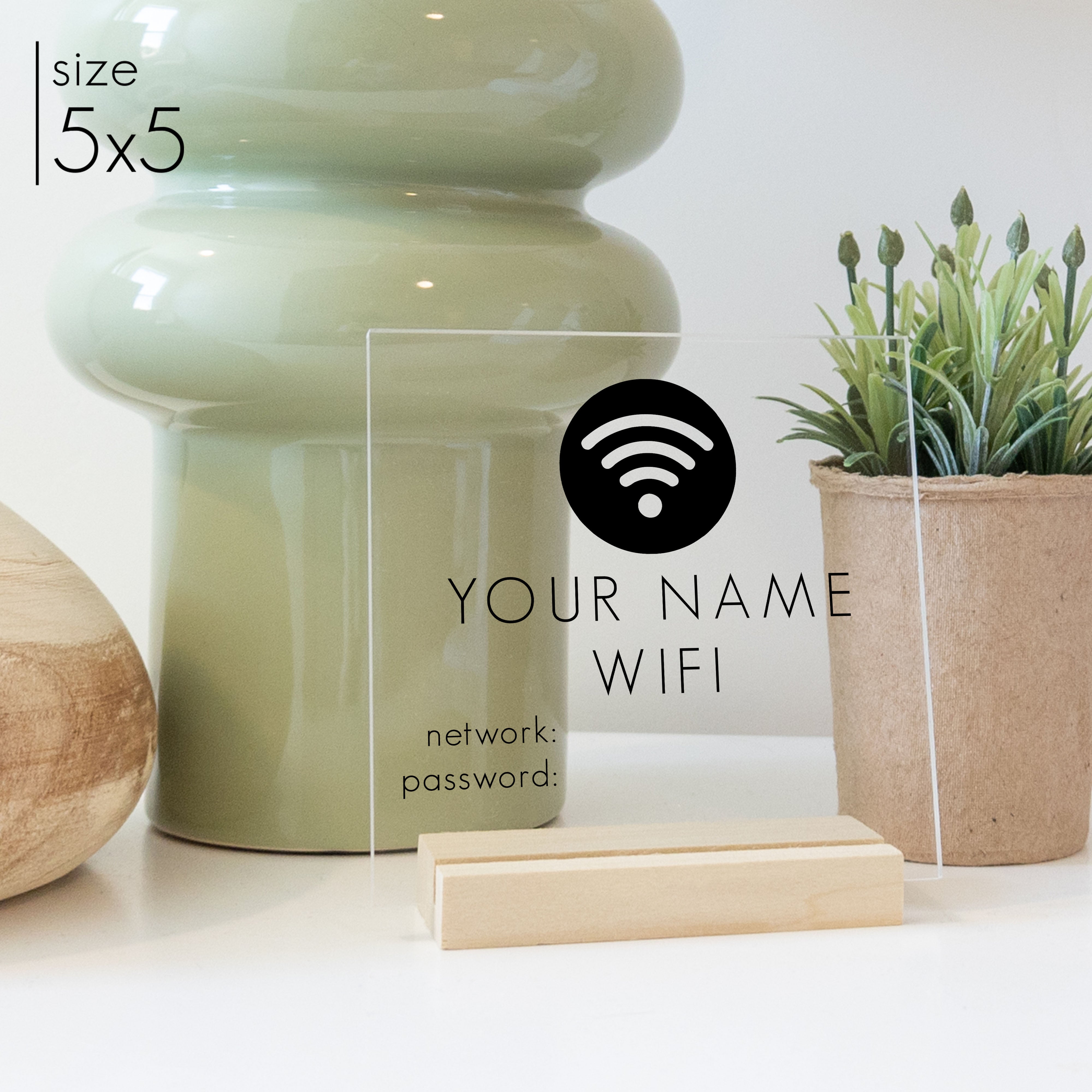 A 5x5 wifi password sign with a blonde stand on a kitchen counter