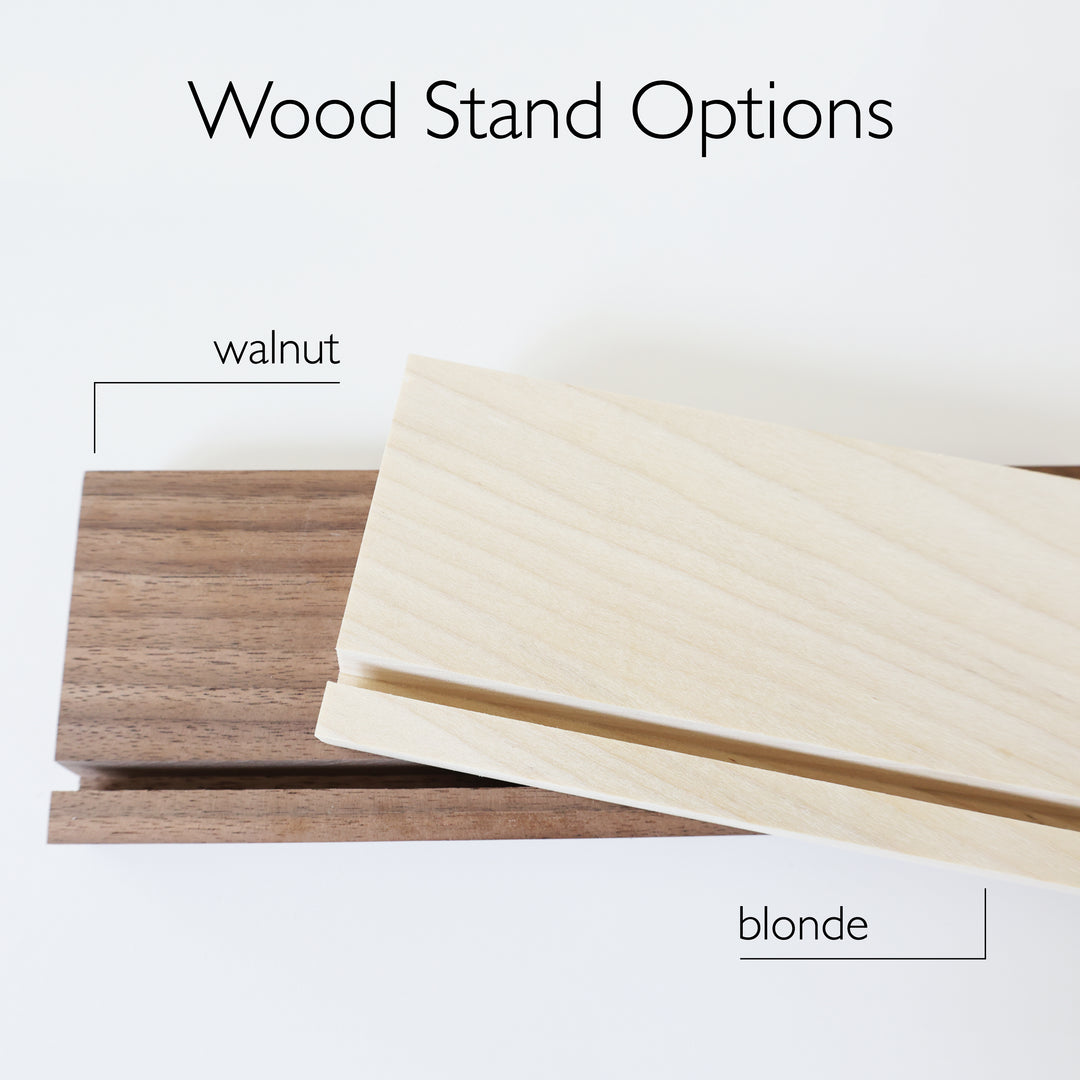 Two wooden stands, one in walnut and one in blonde. 