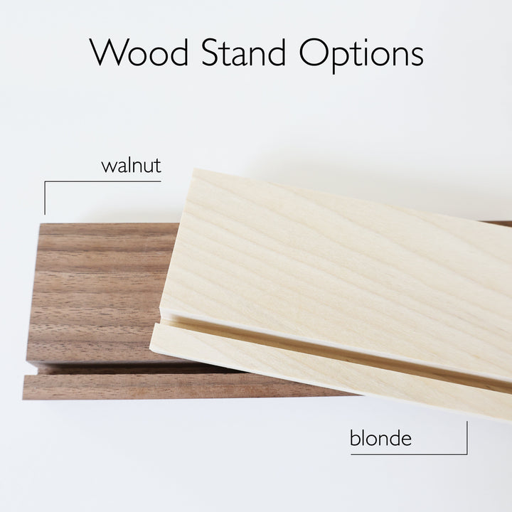 Two wooden stands in the colors walnut and blonde.