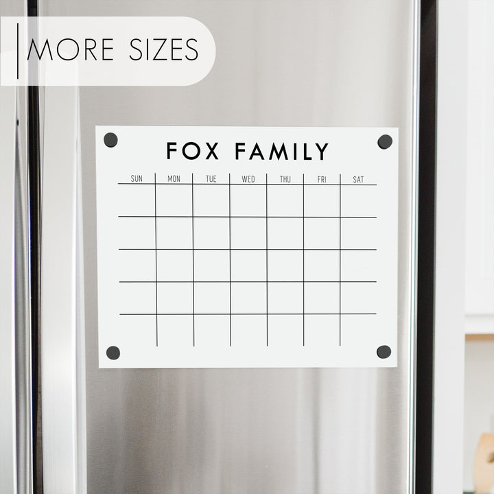 A Dry-erase monthly calender made of acrylic hanging on the fridge