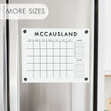 A Dry-erase monthly calender made of acrylic hanging on the fridge