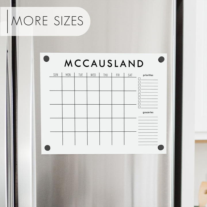 A Dry-erase monthly calender made of acrylic hanging on the fridge