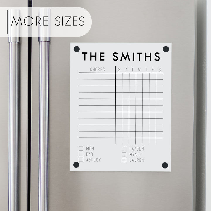 A Dry-erase acrylic chore chart hanging on the fridge