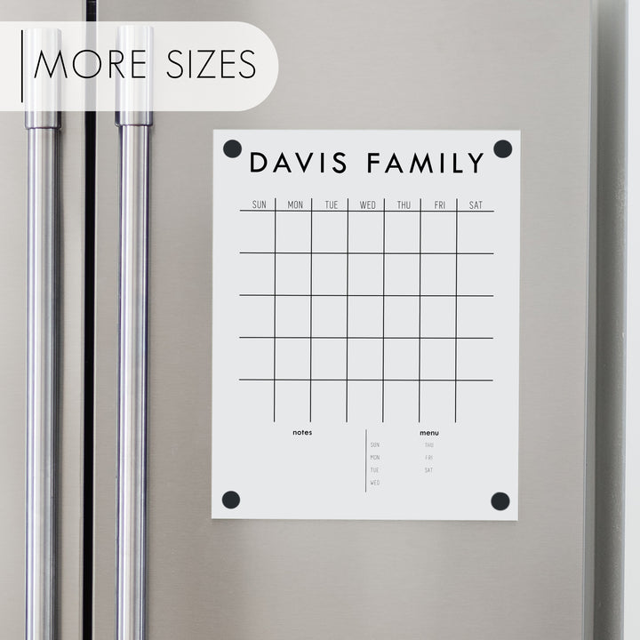 A Dry-erase monthly calender made of acrylic hanging on the fridge