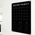 A Dry-erase family command center made of acrylic hanging on the wall